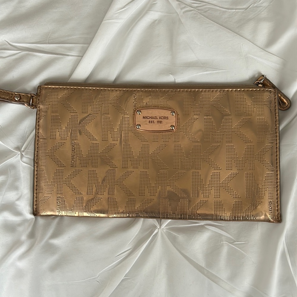 Michael Kors rose gold wristlet.